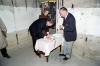 President Reagan signing guest book at Pointe du Hoc gun emplacement.