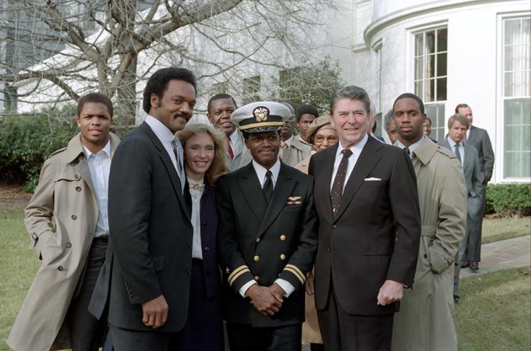 President Ronald Reagan outside the Oval Office with Reverend Jesse Jackson, Terry Lynn Goodman, and Navy Lieutenant Robert O. Goodman, Jr. who was captured December 4, 1983 after his plane was shot down over Syrian controlled territory in Lebanon 01/04/1984  NAID: 276563781