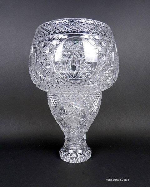 A clear glass punch bowl etched with the seal of the United States Congress and text stating “COMMEMORATION OF VISIT TO GALWAY JUNE 2ND, 1984.” The base of the punch bowl is etched “Galway Crystal.”  Gifter: Mayor Michael Leahy of Galway, Ireland. Artifact ID: 1984.0169301a-b
